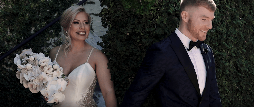 This is picture of a bride and groom sharing their first touch before their ceremony